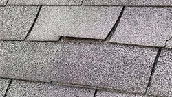 wind damage roofing shingle, charlotte NC, roof storm specialists, grey three tab roofing shingles