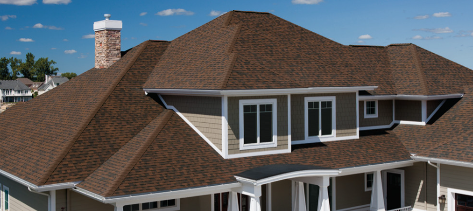 Brown shingle roof on a well-designed house, exemplifying Charlotte Pro Roofing's craftsmanship.